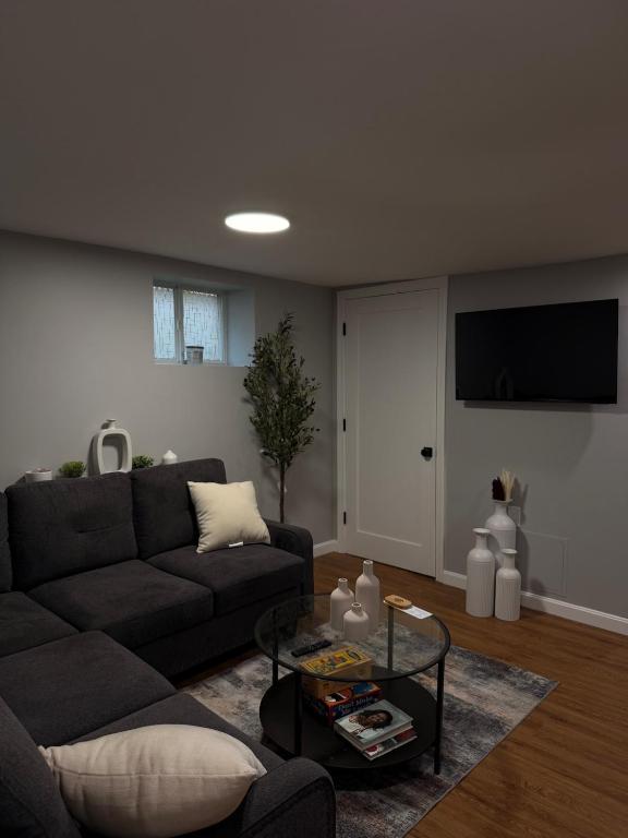 a living room with a couch and a table at Janets Cove in Medford