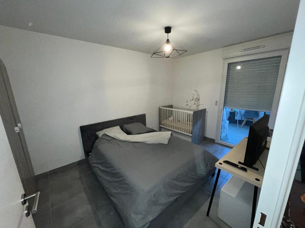 a bedroom with a bed and a desk with a computer at riviera in Nice