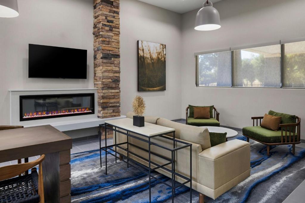 a living room with a couch and a fireplace at Fairfield Inn Sacramento Cal Expo in Sacramento