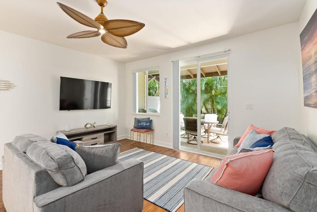 a living room with two couches and a flat screen tv at Luxury Oasis Resort Villa in Honokai Hale