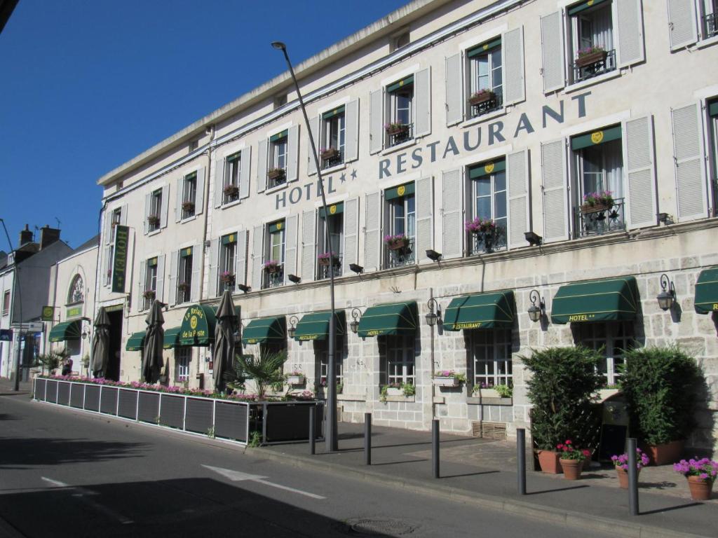 a hotel with a sign on the side of a building at Le Relais De La Poste in Pithiviers