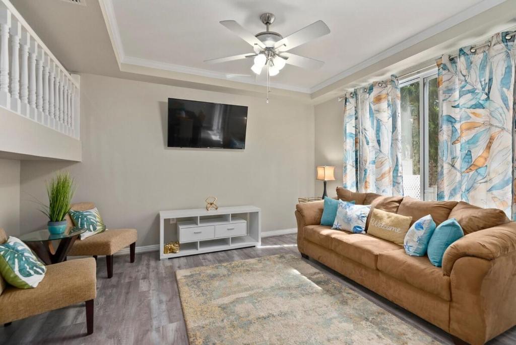 a living room with a couch and a tv at Serene Oasis - Home Away from Home in Honokai Hale