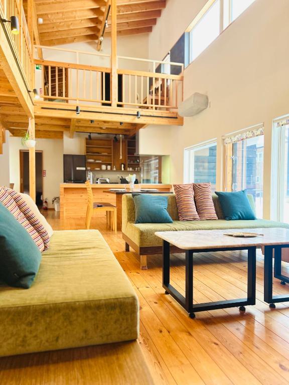 a living room with two couches and a table at Ajito Niseko in Kutchan