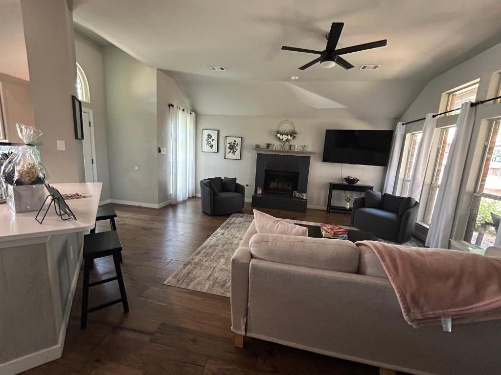a living room with a couch and a ceiling fan at Rockwall Harbor Retreat in Rockwall