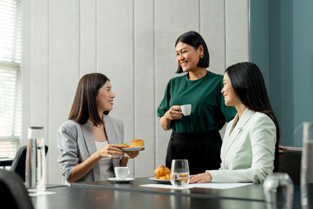 A polished dining setting with pastries, coffee and table service.
