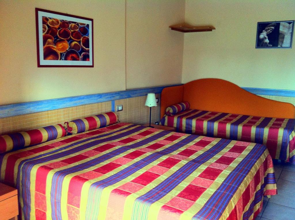 Postel nebo postele na pokoji v ubytování Hotel Morgana