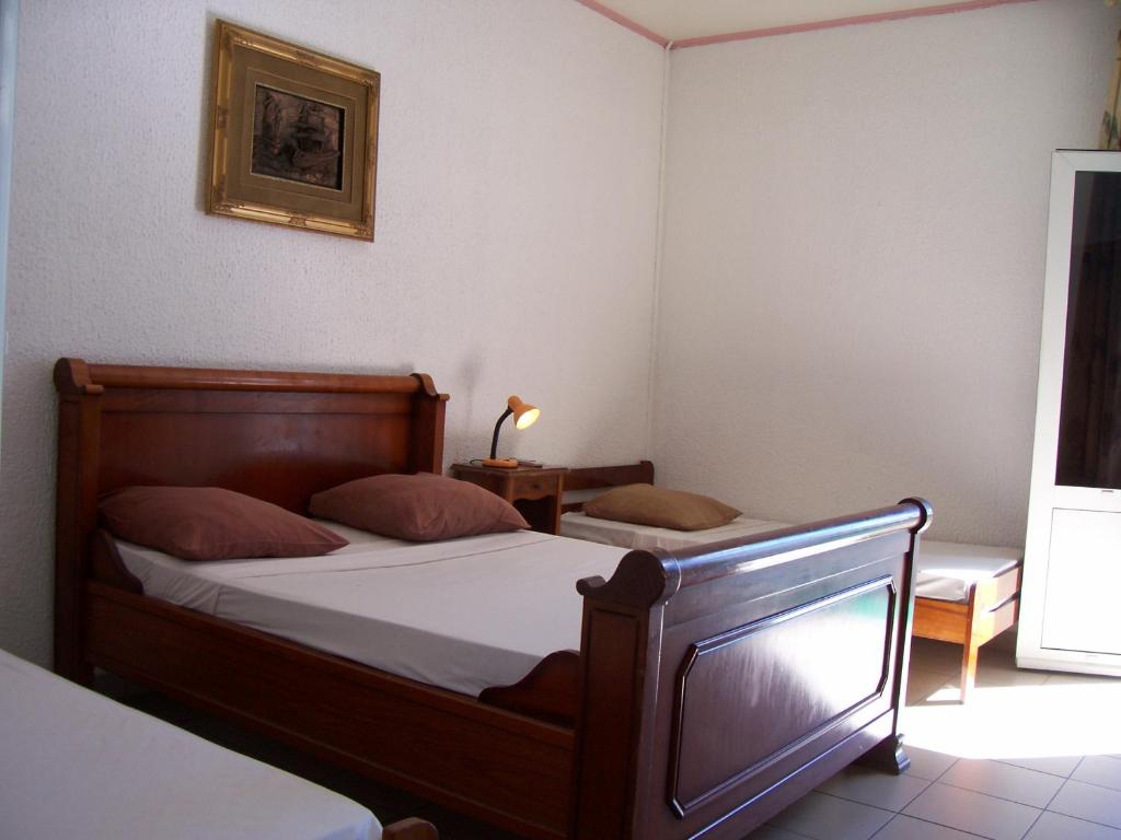 Postel nebo postele na pokoji v ubytování Hôtel Le Nathania