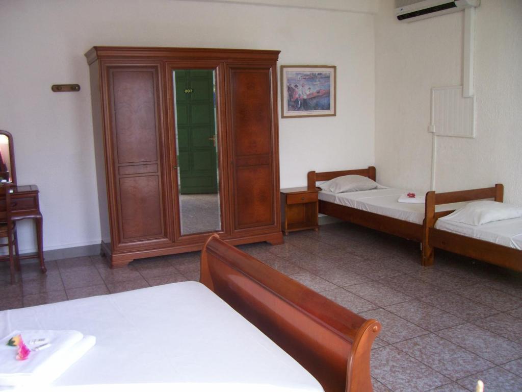 Postel nebo postele na pokoji v ubytování Hôtel Le Nathania