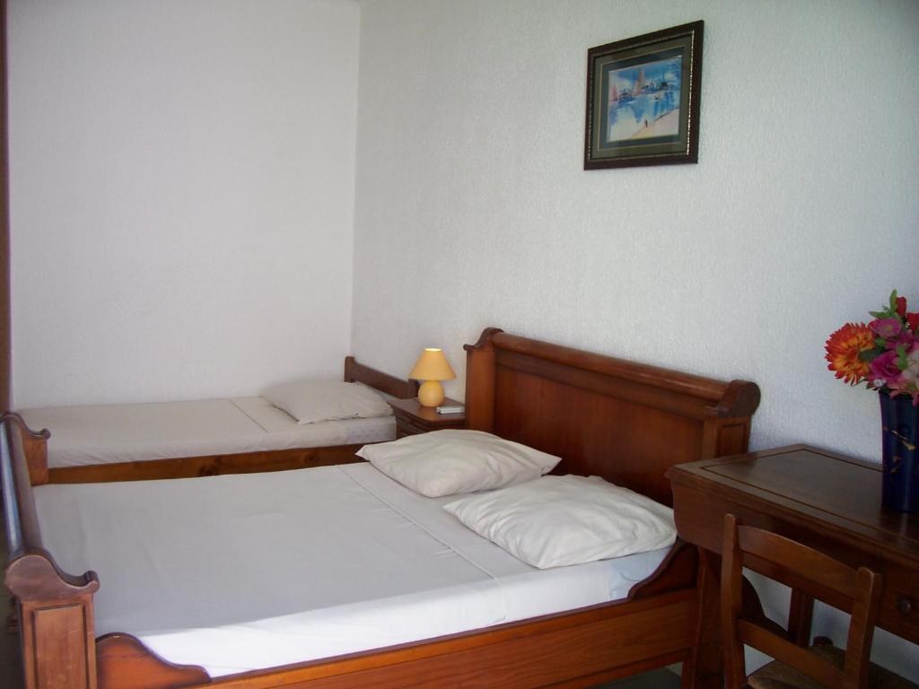 Postel nebo postele na pokoji v ubytování Hôtel Le Nathania