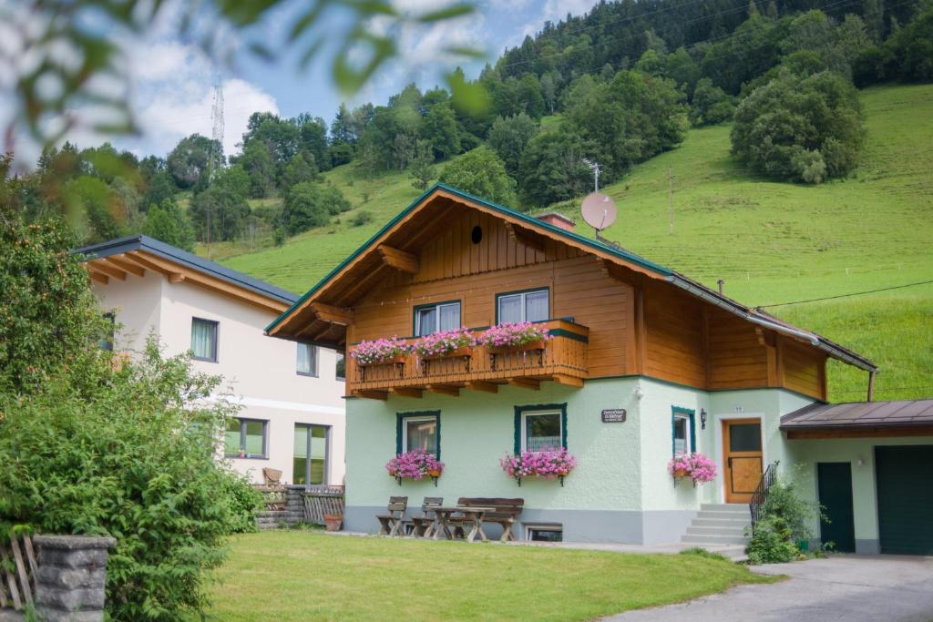 a house with a balcony with flowers on it at Ferienhaus Evi in Schladming