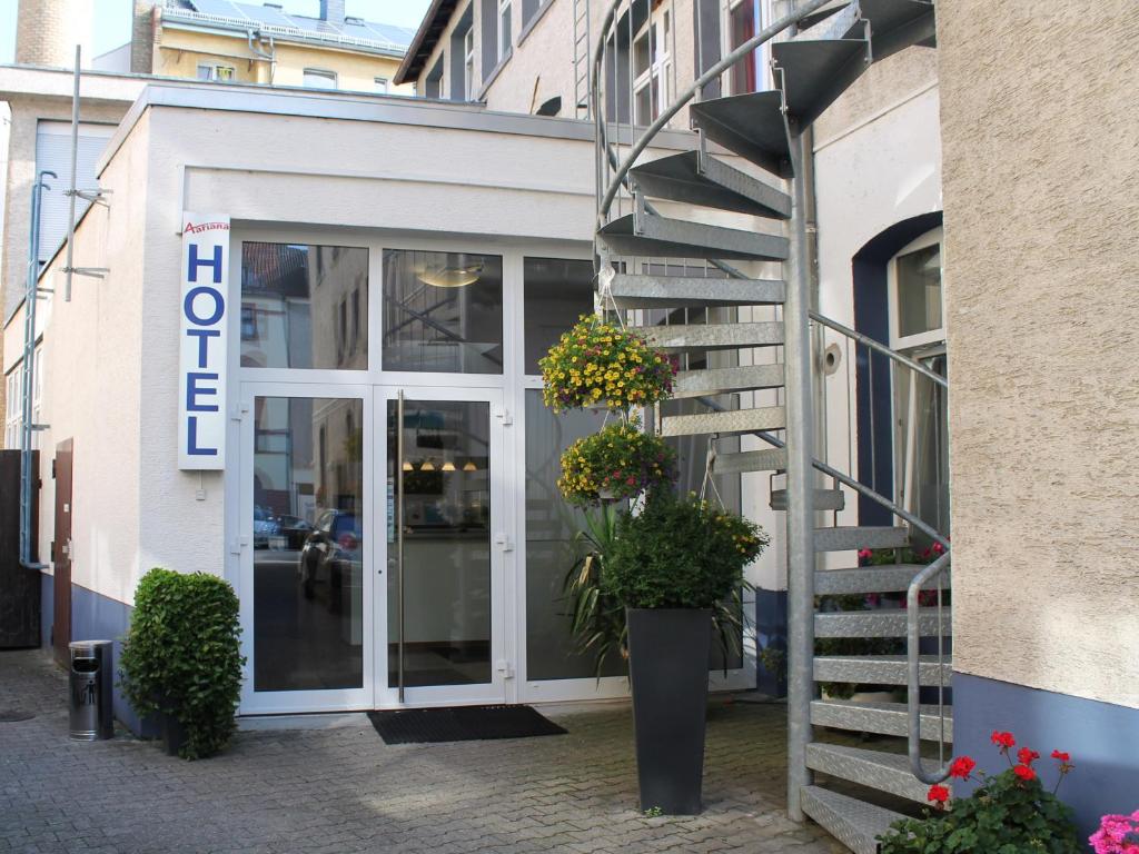 a building with a staircase in front of a store at Aariana Hotel in Offenbach