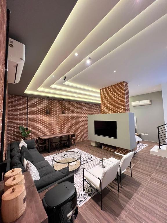 a living room with a couch and a tv at luxury basement studio in Riyadh