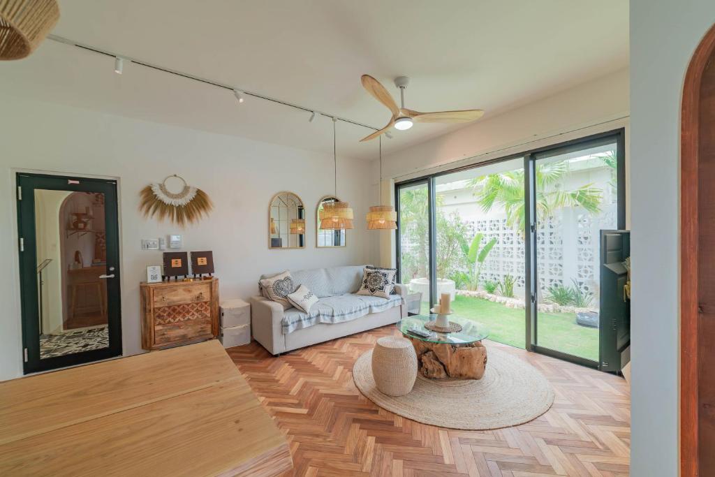 a living room with a couch and a table at The House By The Sea in Miyako Island
