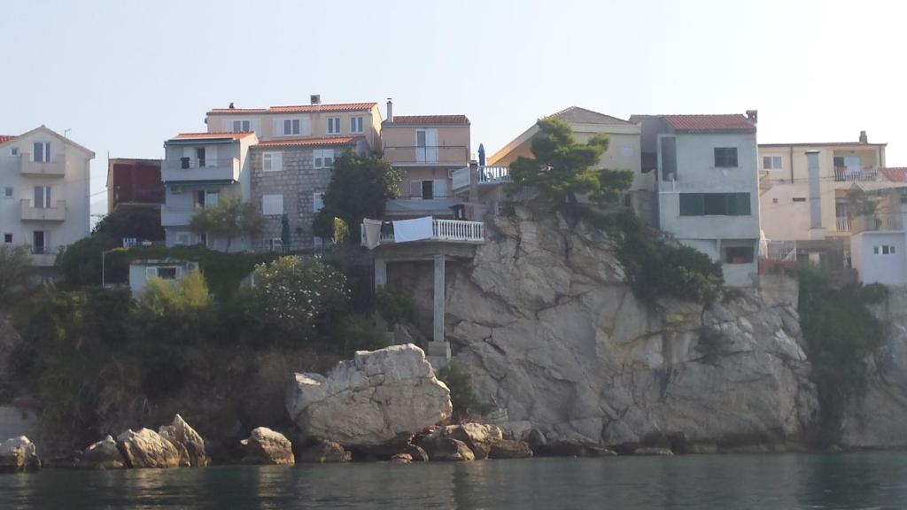 a group of houses on top of a rocky cliff at Apartment Gevera in Split