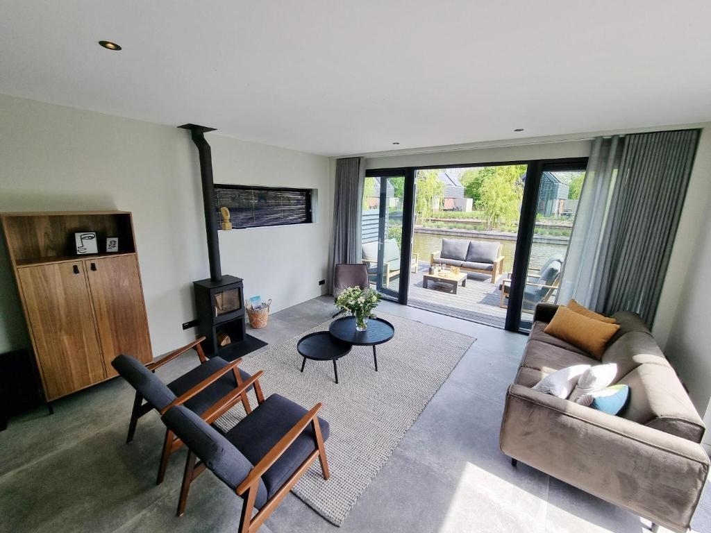 a living room with a couch and a table at Luxurious detached water villa with jetty in Balk