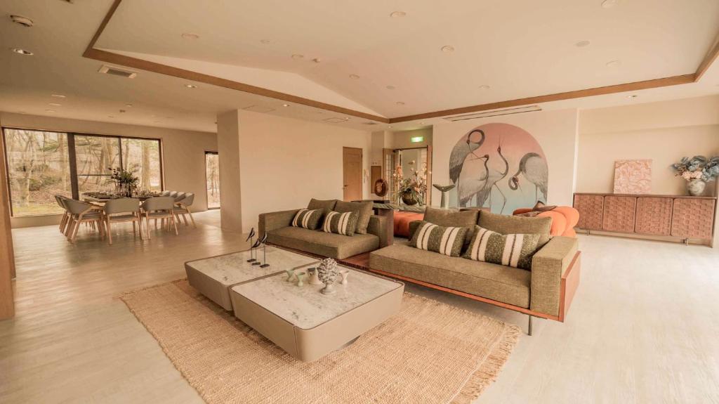 a living room with a couch and a table at 來Lai 北軽井沢Resort Villa 158 in Tsumagoi