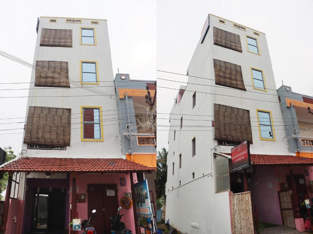 Arun Auro Residency في Kuilapayam: مبنى أبيض طويل وبه متجر أمامه
