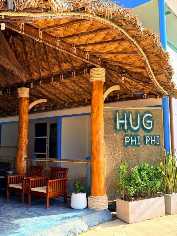 a restaurant with two benches under a pergola at HUG PHIPHI Resort in Phi Phi Islands