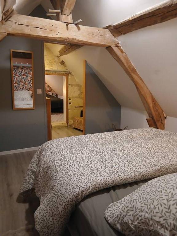 a bedroom with a bed in a attic at Ma Maison Vigneronne in Loches