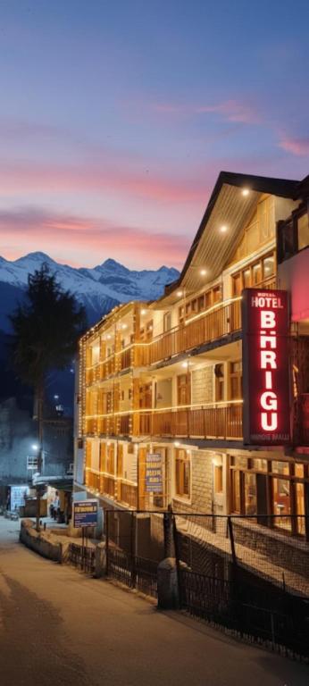 a building with a sign on the side of it at Hotel BHRIGU in Manāli