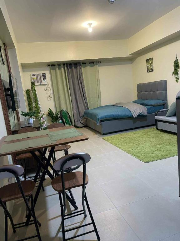 a living room with a couch and a table and chairs at Stena Stays 219 in Kaybagal