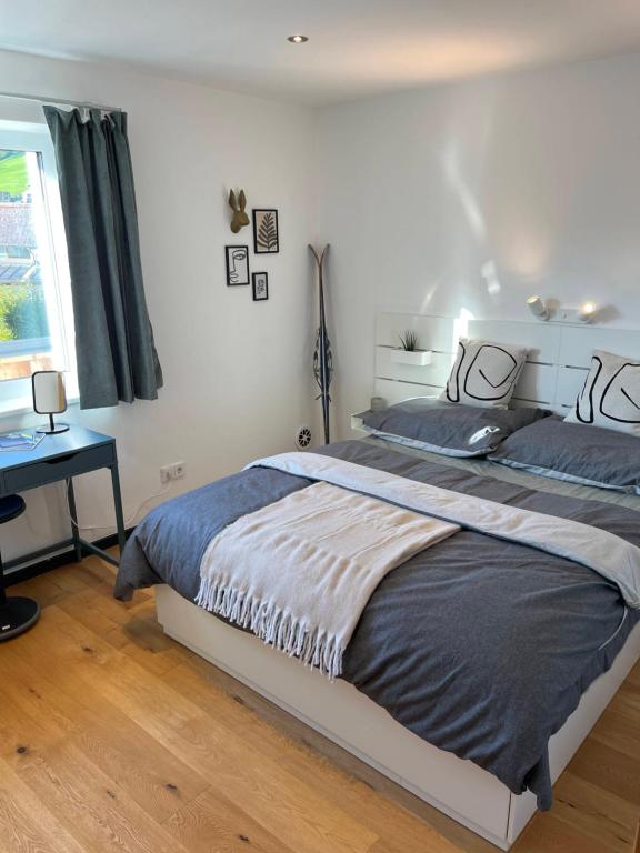 a bedroom with a large bed and a window at Central Hideaway in Maria Alm am Steinernen Meer