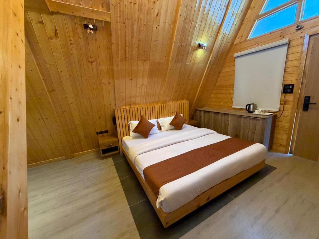 um quarto com uma cama em um quarto de madeira em Muskan Mount View Retreat, Mukteshwar em Mukteswar