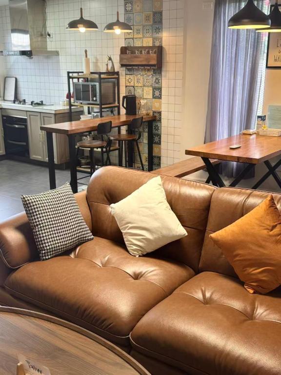 a brown leather couch with pillows on it in a kitchen at Mira Apartments 2BR Apartment in Nadi Free Parking & WiFi in Nadi