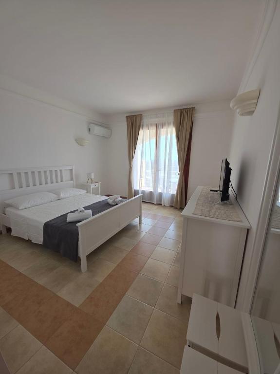 Ένα ή περισσότερα κρεβάτια σε δωμάτιο στο Is Molas Domus Michela