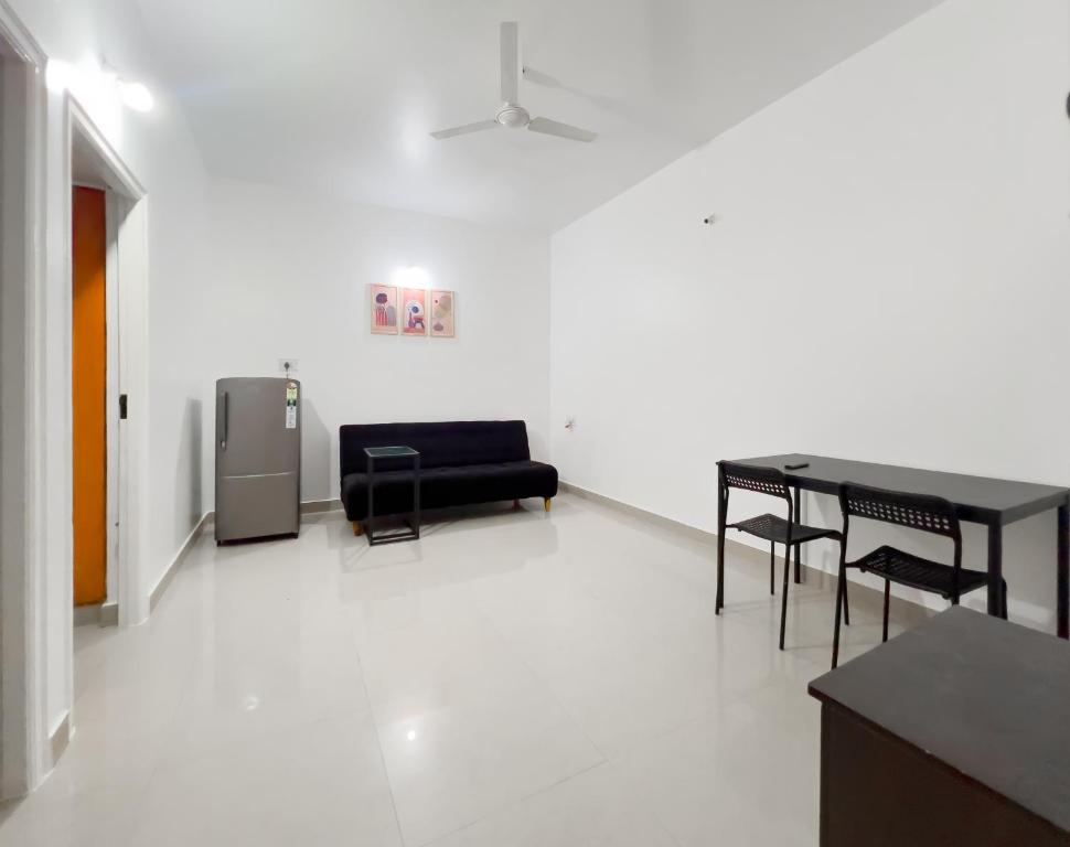 a room with a table and chairs and a couch at The Pinnacle - Electronic City in Bengaluru