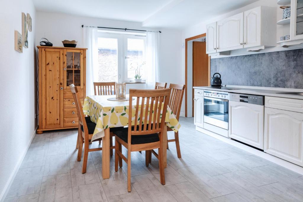 a kitchen with a table and chairs in a kitchen at Ferienwohnung Alte Scheune in Westerburg