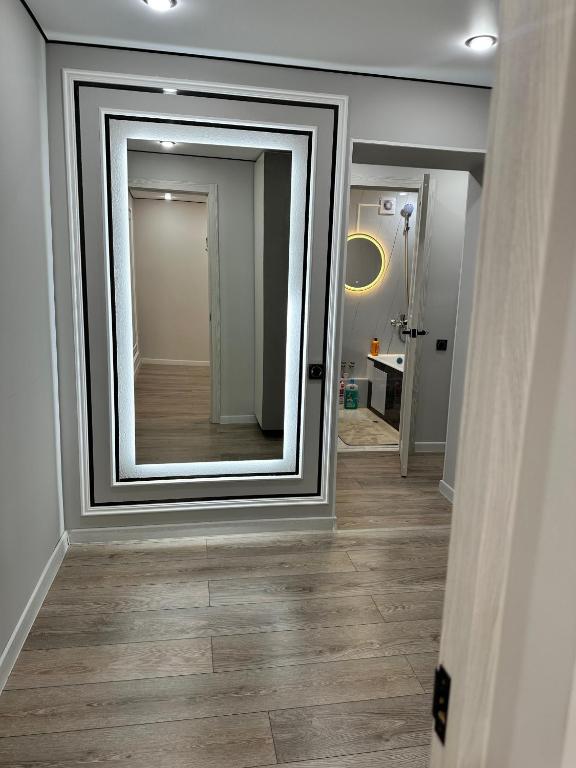 a large mirror on the wall of a hallway at Сатпаева, Телецентр in Taraz