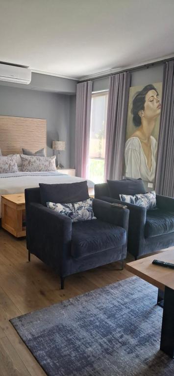 a living room with a couch and a bed at 112 Luxury Studio at The Gallery in Knysna