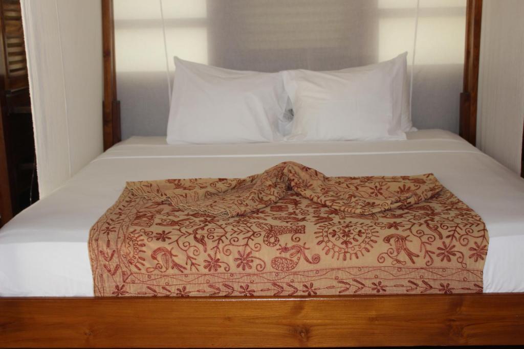 Postel nebo postele na pokoji v ubytování Acajou Hotel