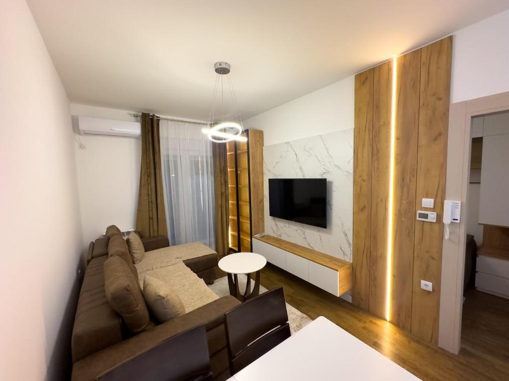 a living room with a couch and a tv at I&I Bubanj in Kragujevac