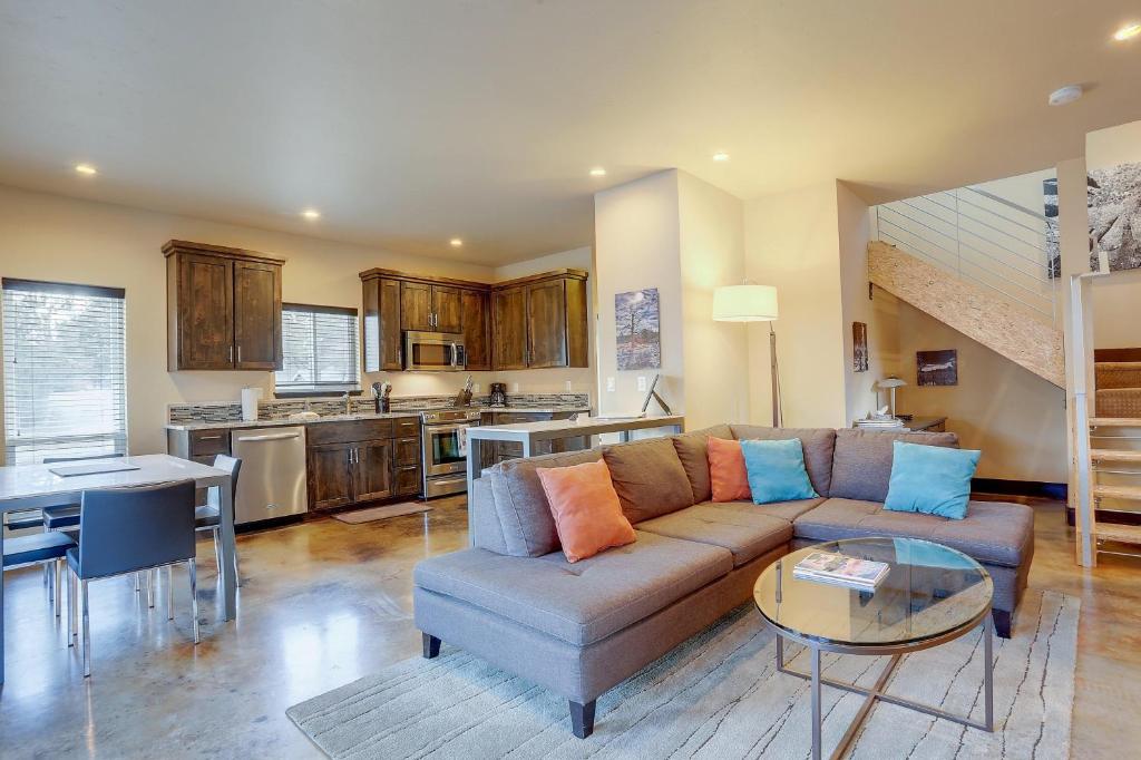 a living room with a couch and a table at Urban Roundabout in Bend
