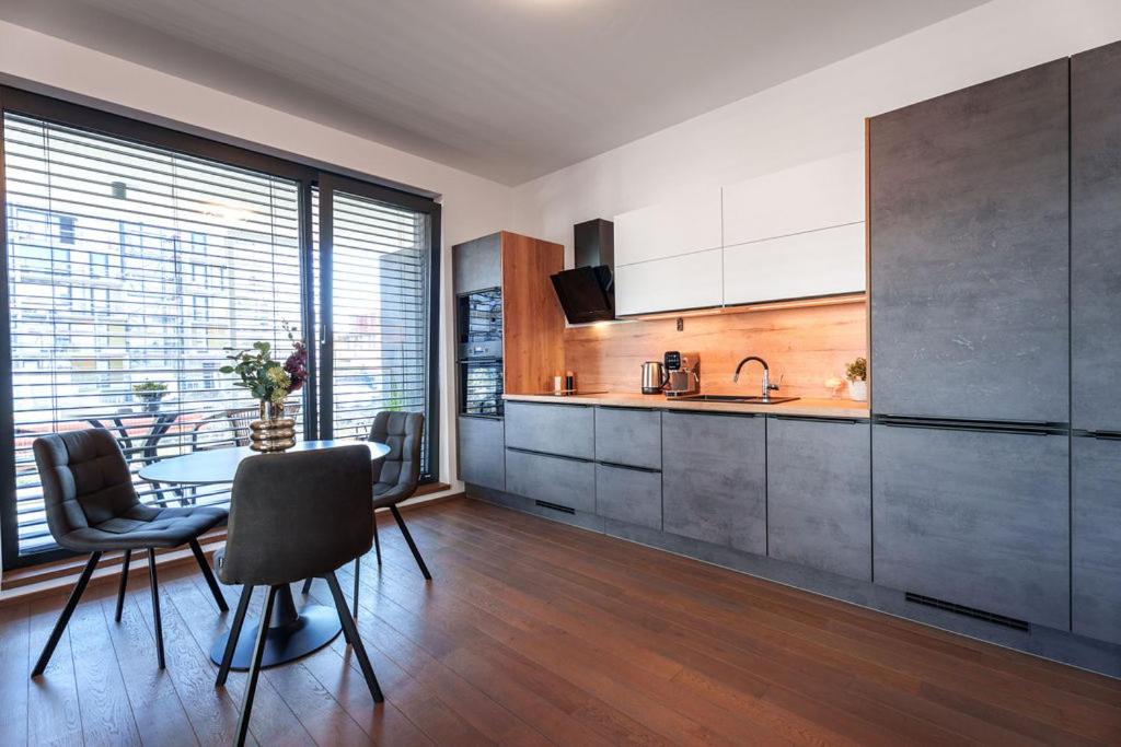 a kitchen with a table and chairs in a room at Šantovka Residence in Olomouc