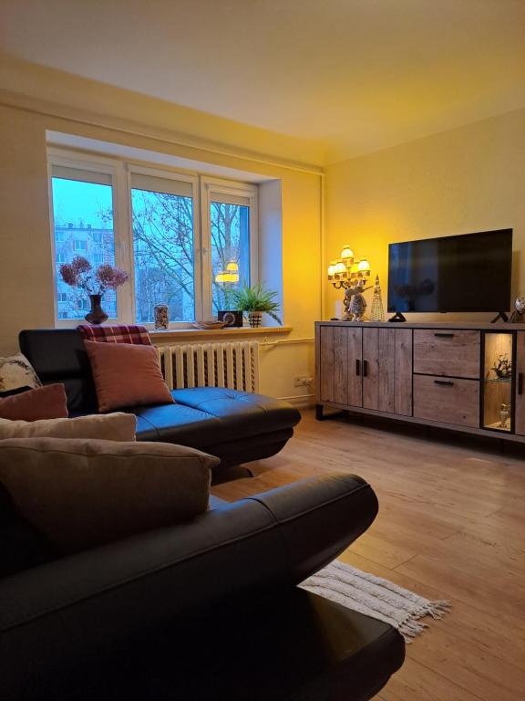 a living room with a couch and a flat screen tv at Sea nest in Jūrmala