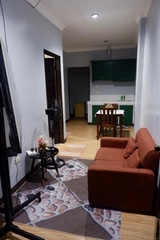 a living room with a couch and a flat screen tv at Arcova Residences 2BR Apartment in San Carlos