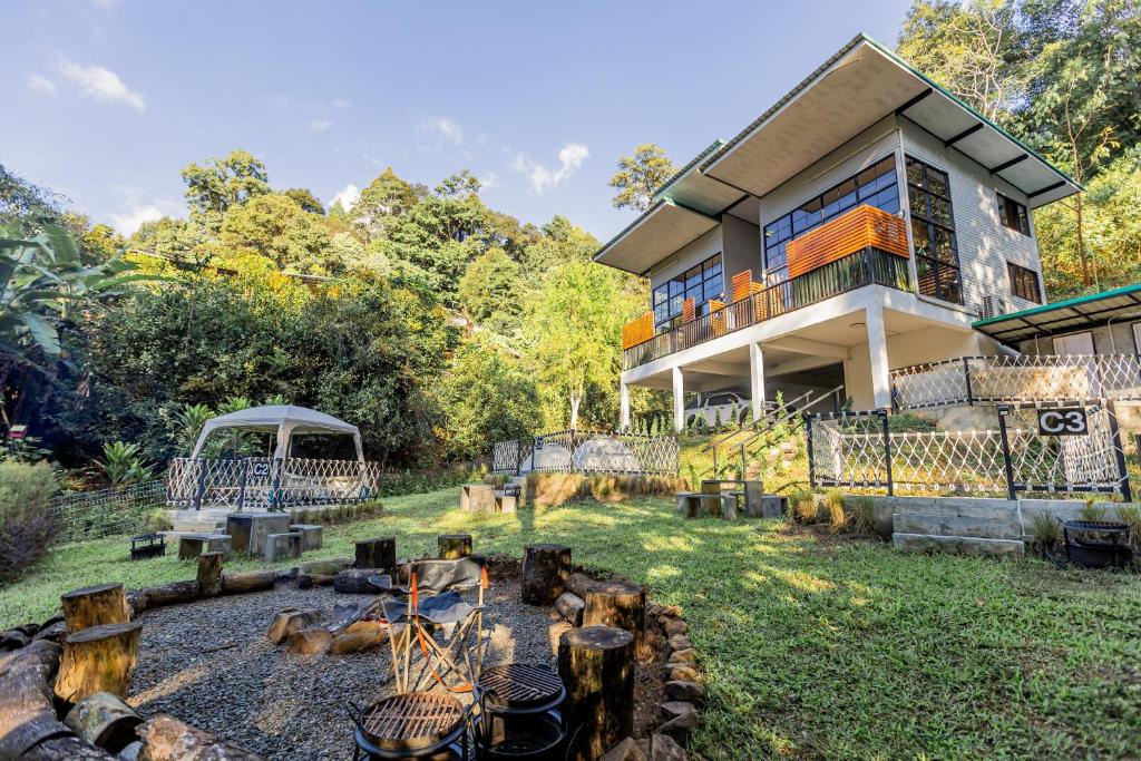a house with a garden in front of it at ZIP House Camping in Ban Pang Haen