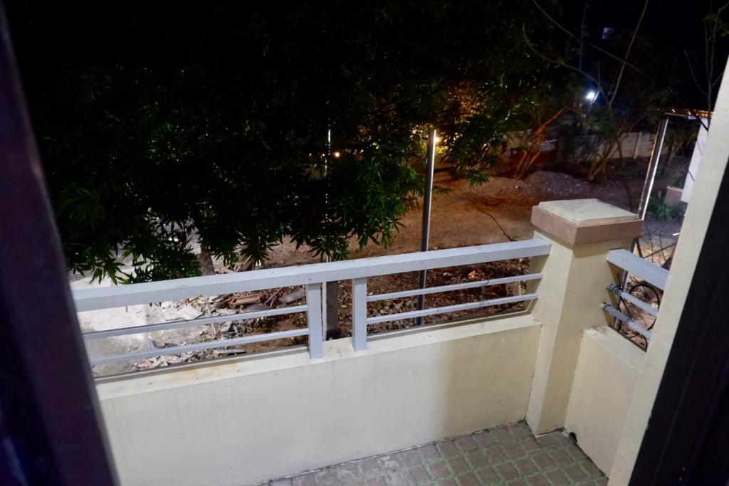 a view of a white fence at night at Arcova Residences 2BR Apartment in San Carlos