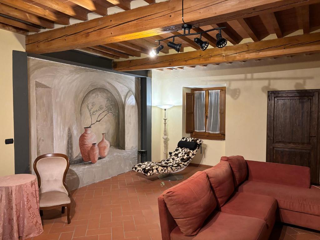 a living room with a couch and some chairs at Borgo La Valle in Palazzo del Pero