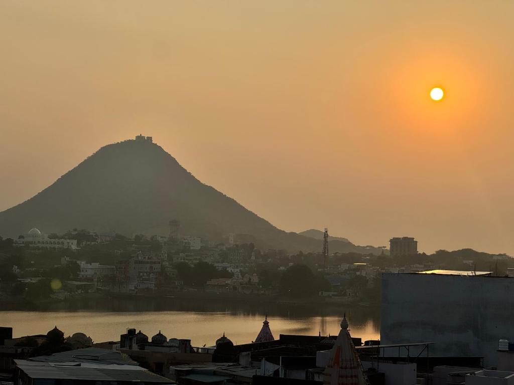 a view of a mountain with the sun in the sky at Pink Floyd in Pushkar