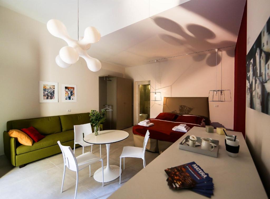 a living room with a green couch and a table at Soggiorni Canario in Matera