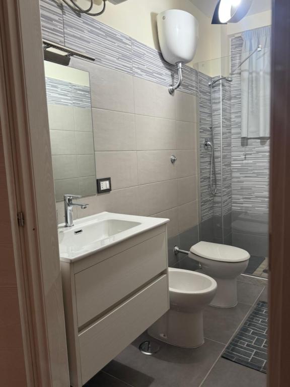 a bathroom with a sink and a toilet at B&B centro baia domizia in Baia Domizia
