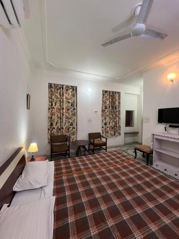 a large room with a bed and a flat screen tv at Doongri Haveli in Jaipur