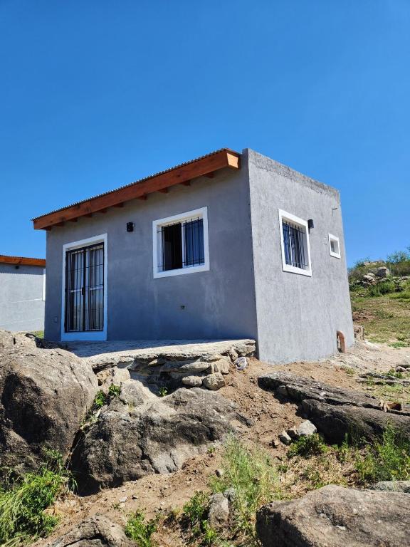 een klein huis bovenop enkele rotsen bij Complejo Altavista in La Falda
