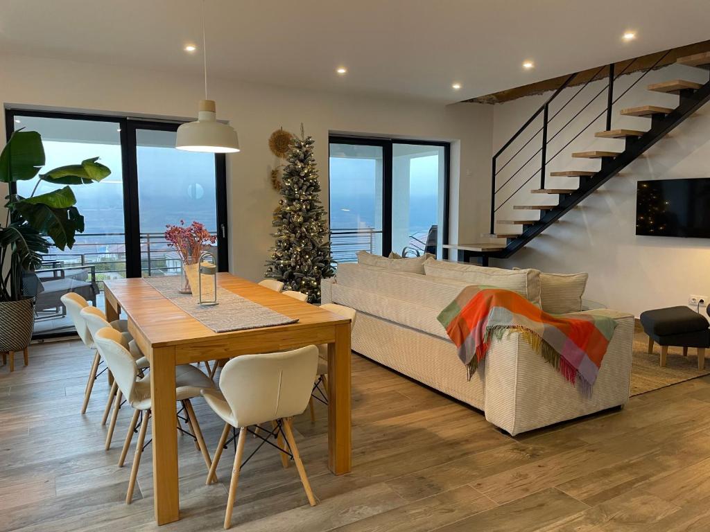 a living room with a table and a couch at Sunset Hills Transylvania Upper in Odorheiu Secuiesc