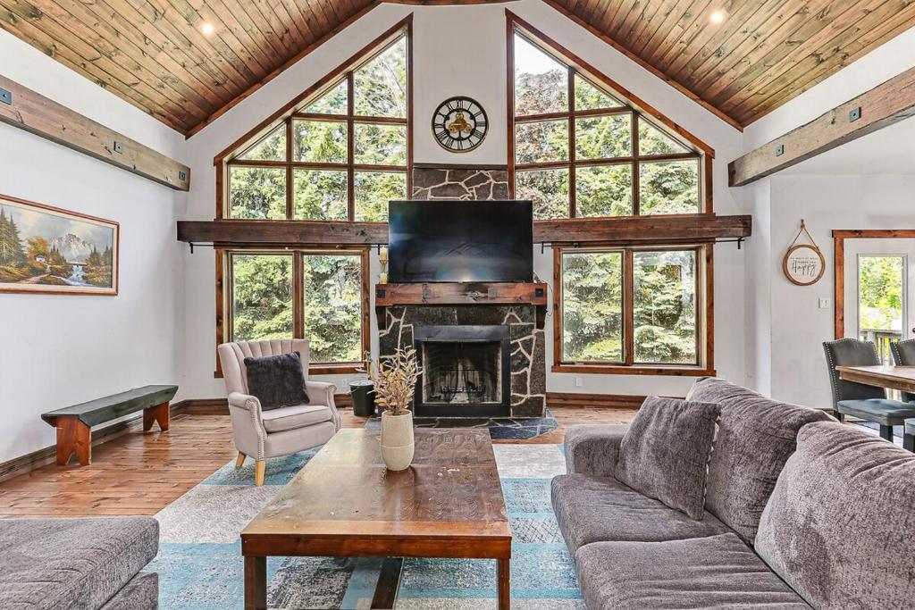 a living room with a couch and a fireplace at Chalet at Blue in Blue Mountains