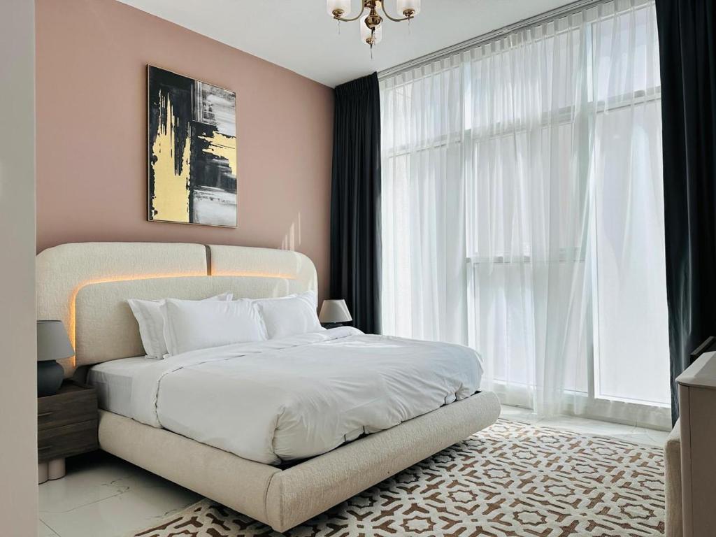 a bedroom with a white bed and a large window at Executive 1BR - Perfect for DIFC & Trade Center in Dubai